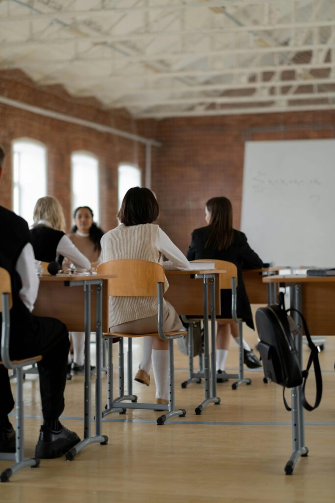 Services Students studying in a high school classroom. Diverse group focused on learning.